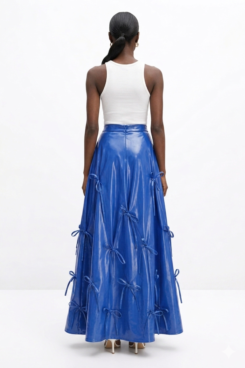 Woman wearing a white top and blue  KINGDOM OF DAUGHTERS skirt on a white background
