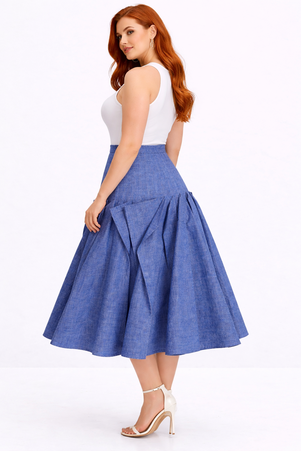 Woman wearing a blue denim skirt and white top on a white background