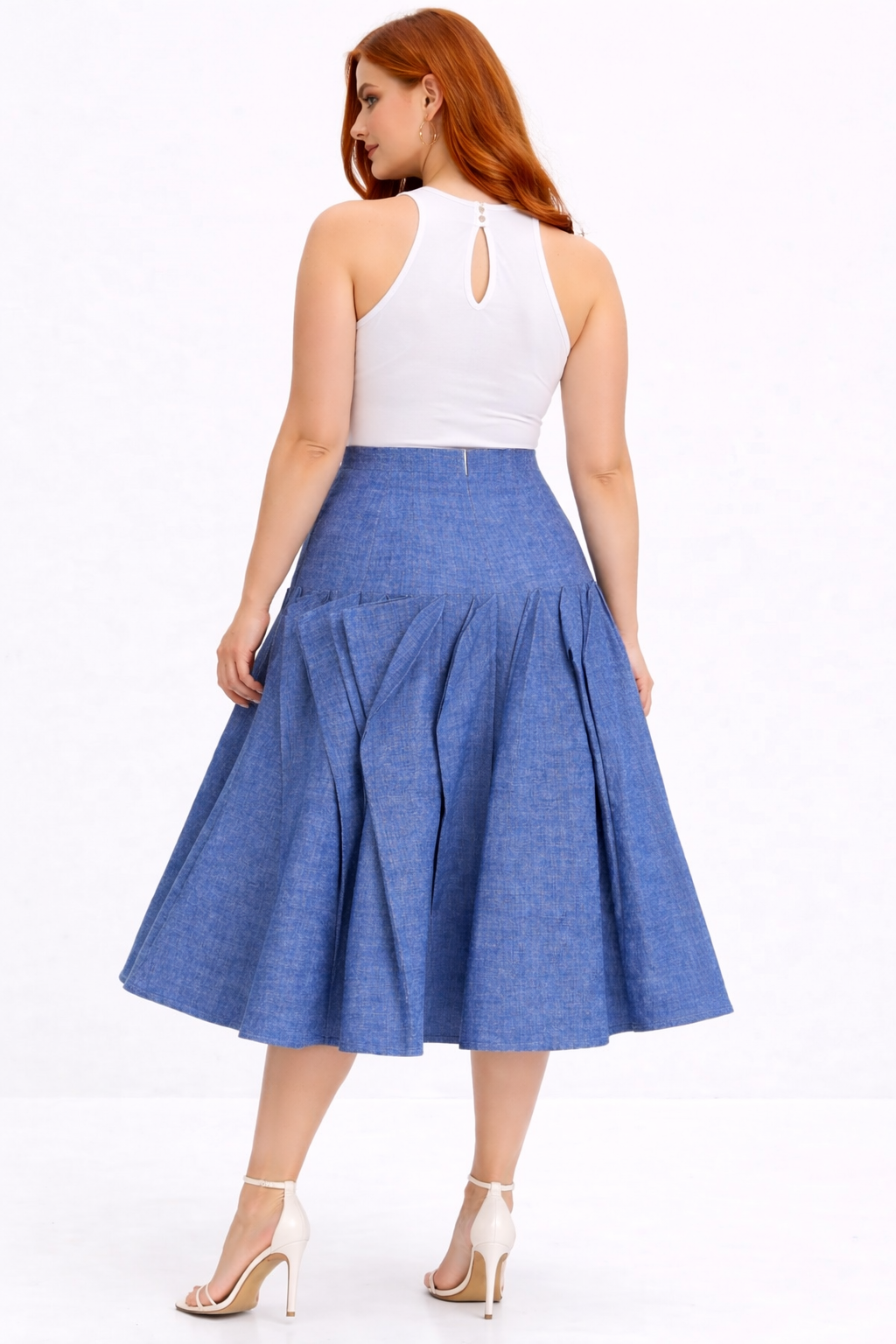 Woman wearing a white top and blue denim skirt on a white background