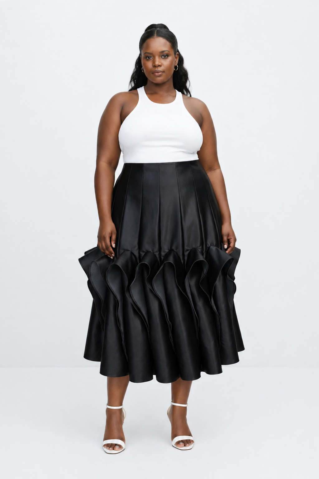 Woman wearing a white top and black ruffled skirt on a white background