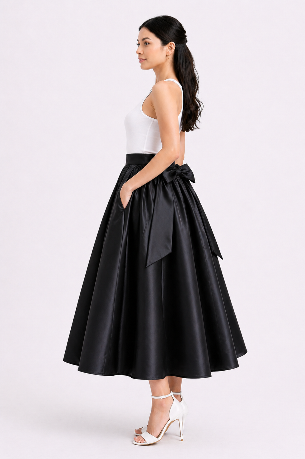 Woman wearing a black skirt with a bow on a white background