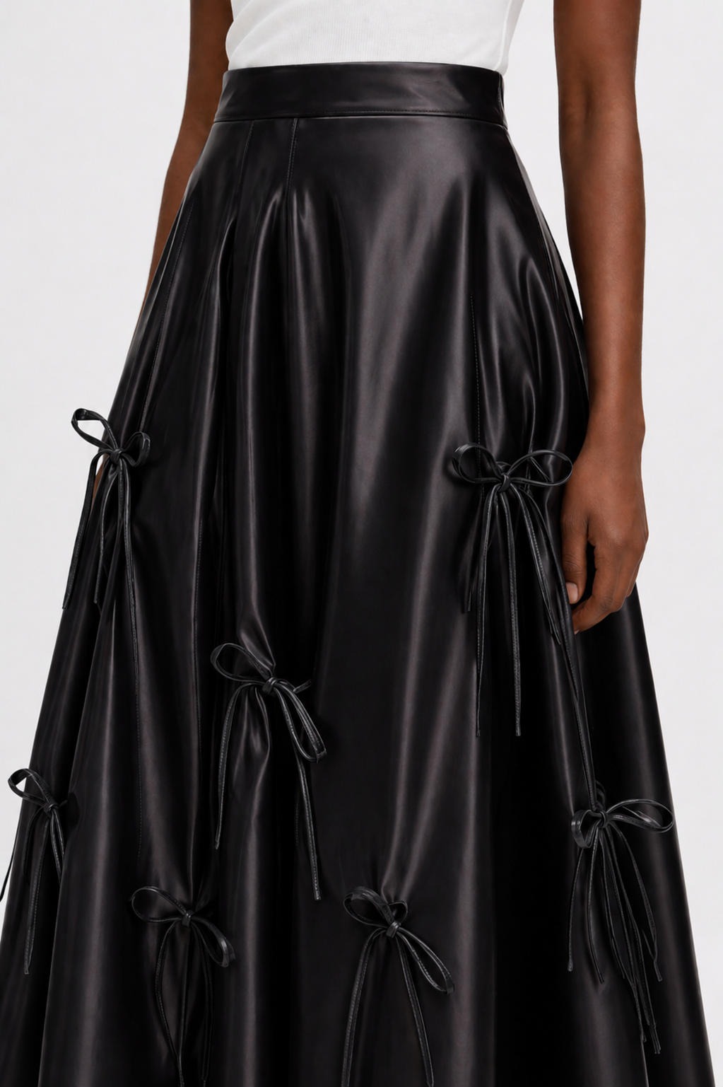 Black leather skirt with tie details on a white background