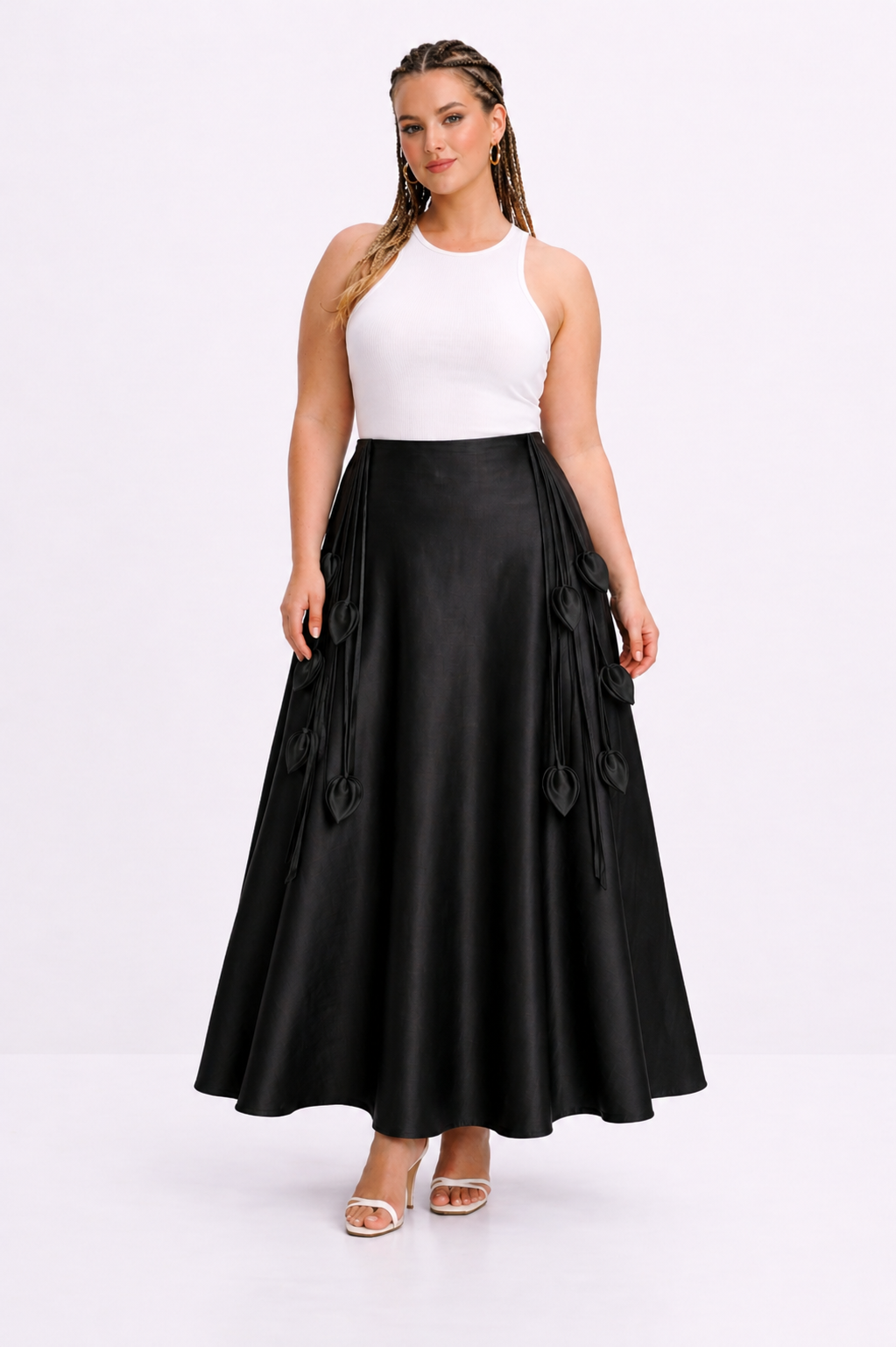 Woman wearing a white top and black skirt on a white background