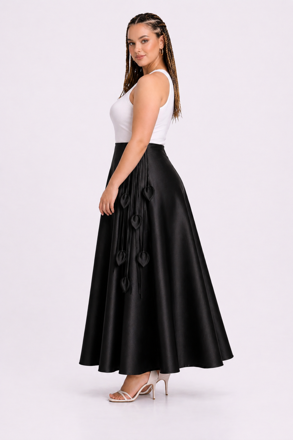 Woman wearing a black skirt with a white top on a white background