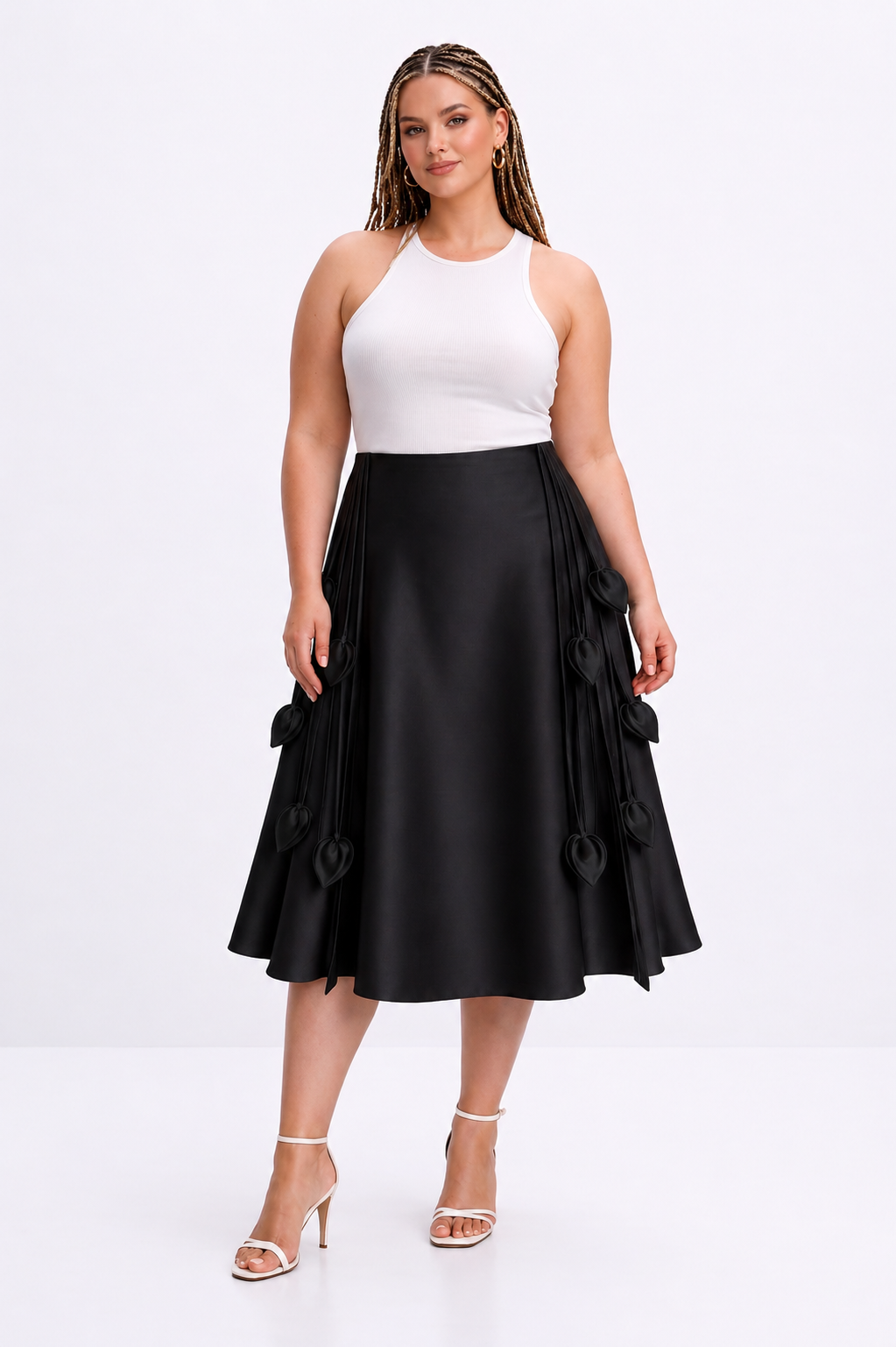 Woman wearing a white top and black skirt on a white background
