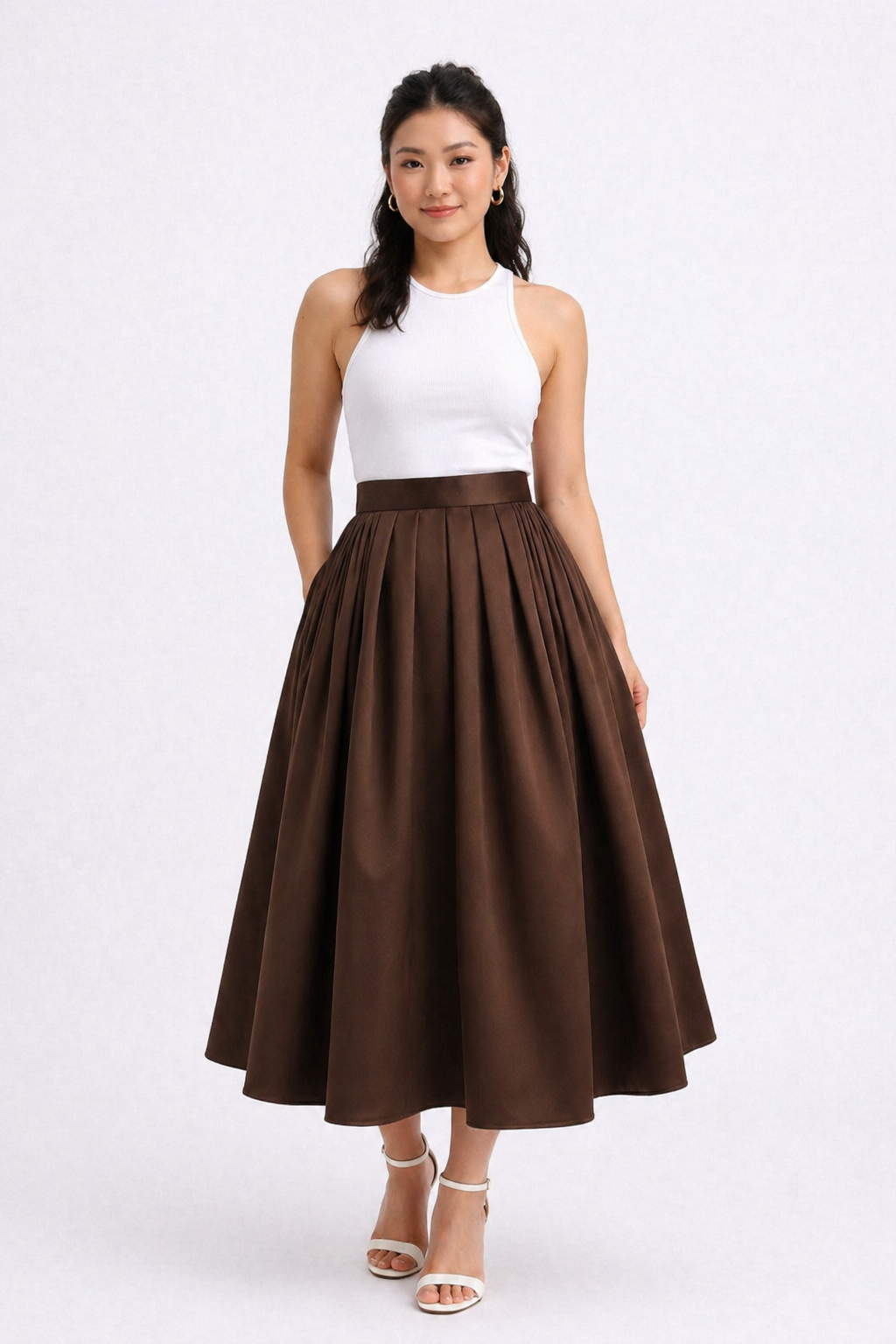 Woman wearing a white top and brown skirt on a white background