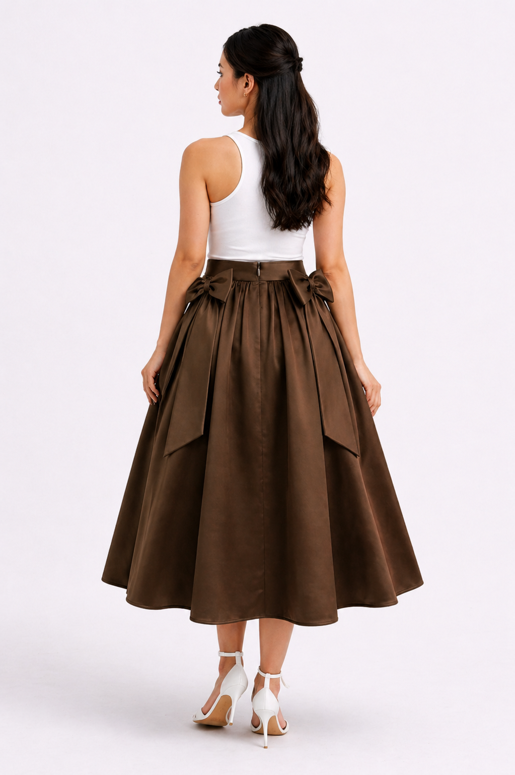Woman wearing a brown skirt and white top on a white background