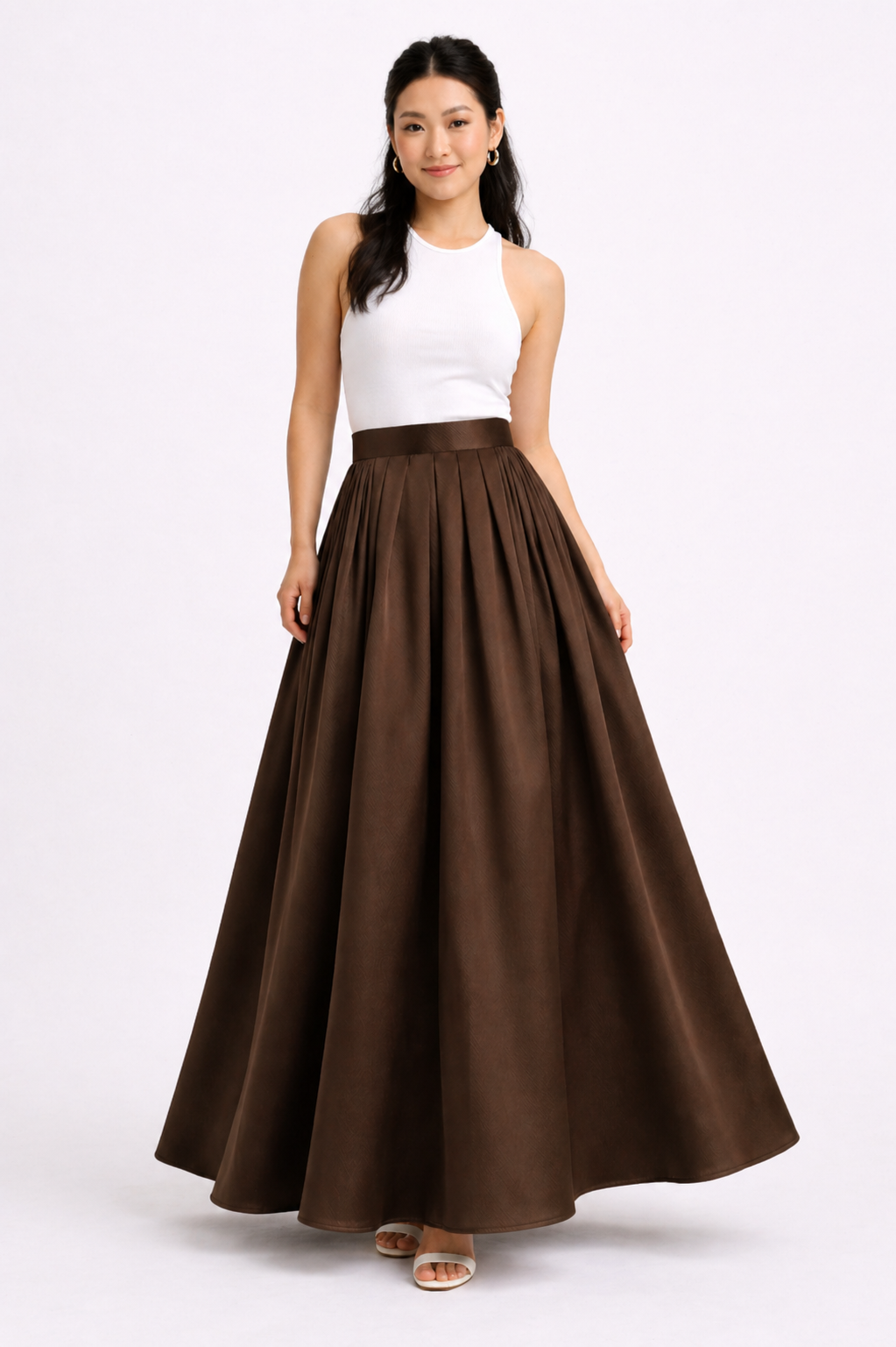Woman wearing a white top and brown long skirt on a white background