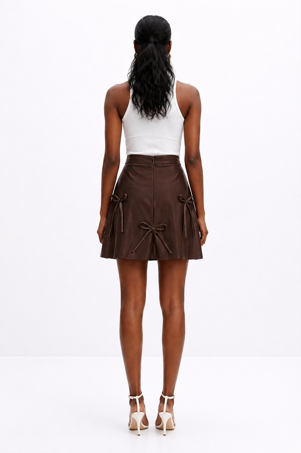 Woman wearing a brown skirt with white top on a white background