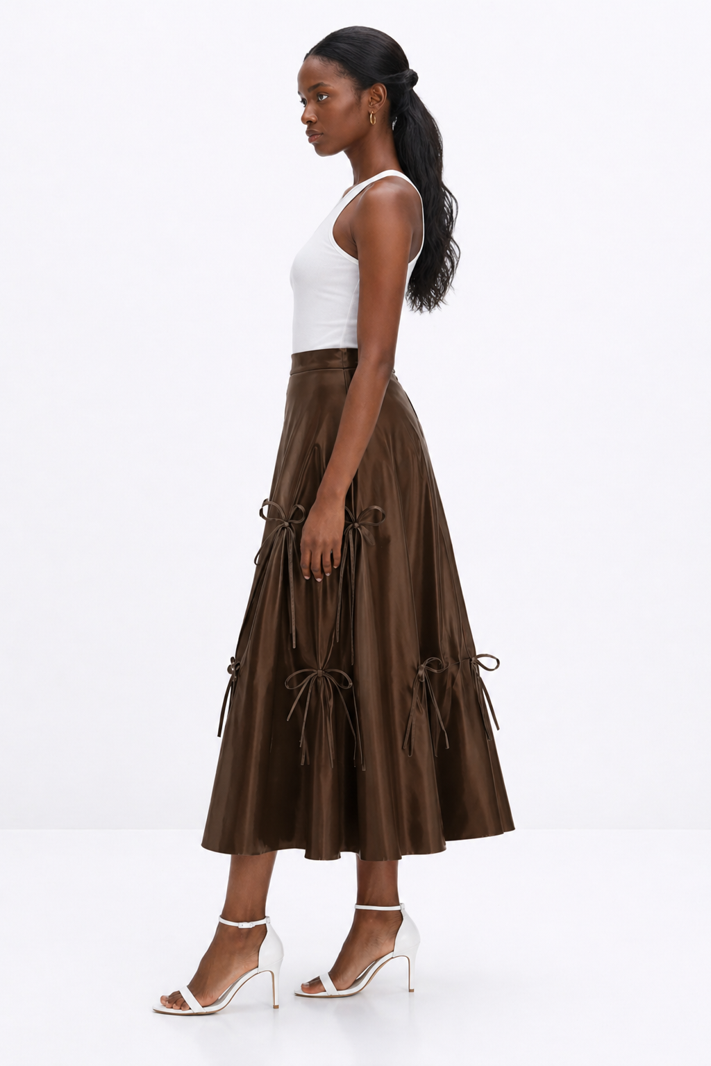Woman wearing a brown skirt with white top on a white background