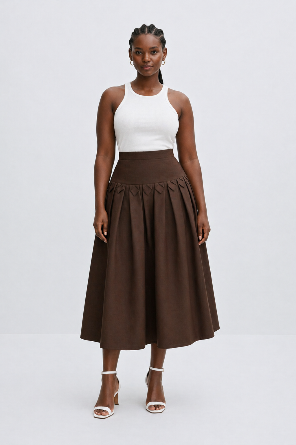 Woman wearing a white top and brown skirt on a white background