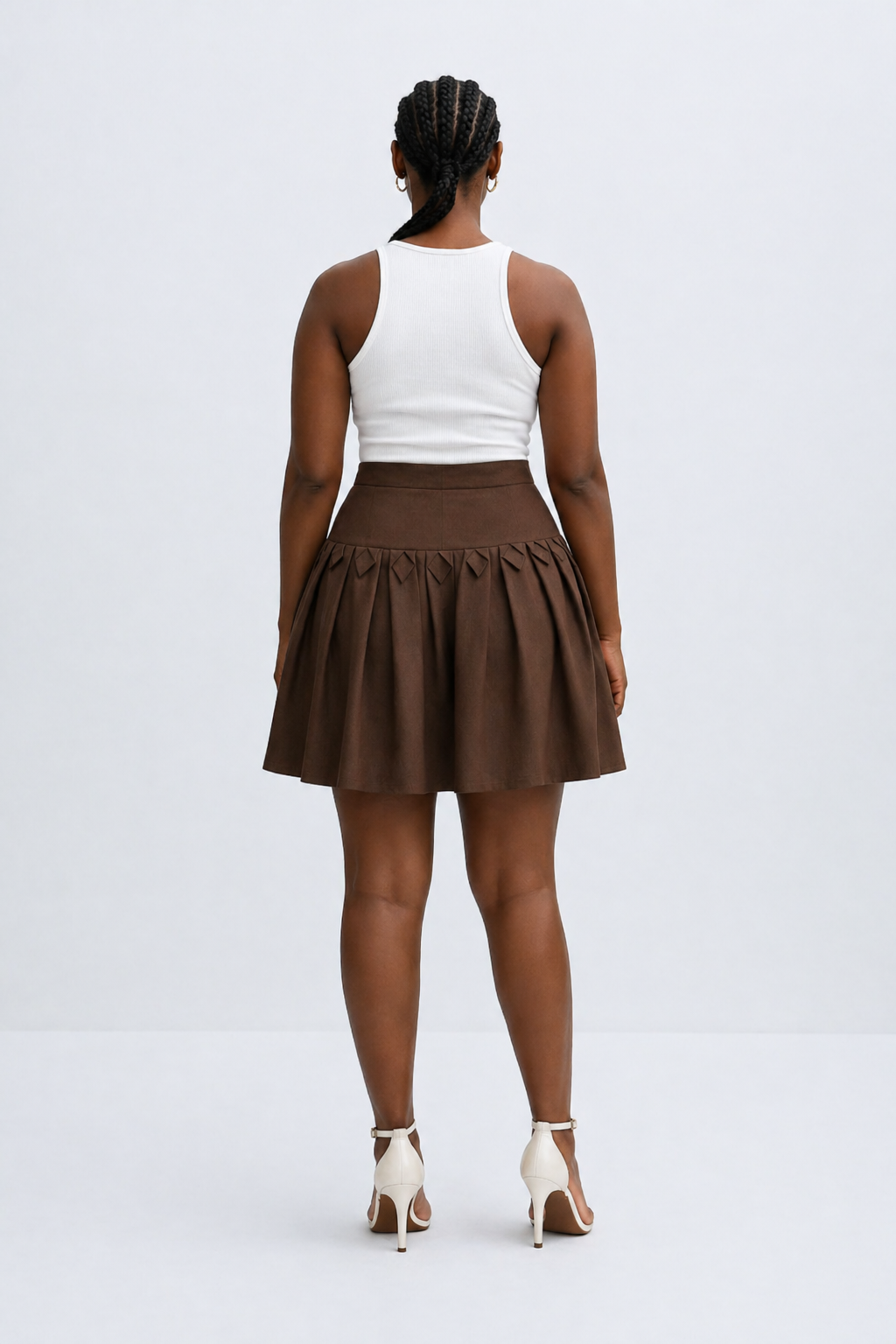 Person wearing a white top and brown skirt on a white background