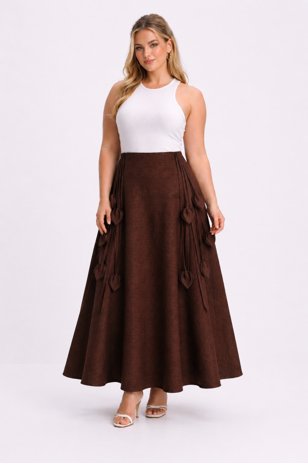 Woman wearing a white top and brown skirt on a white background