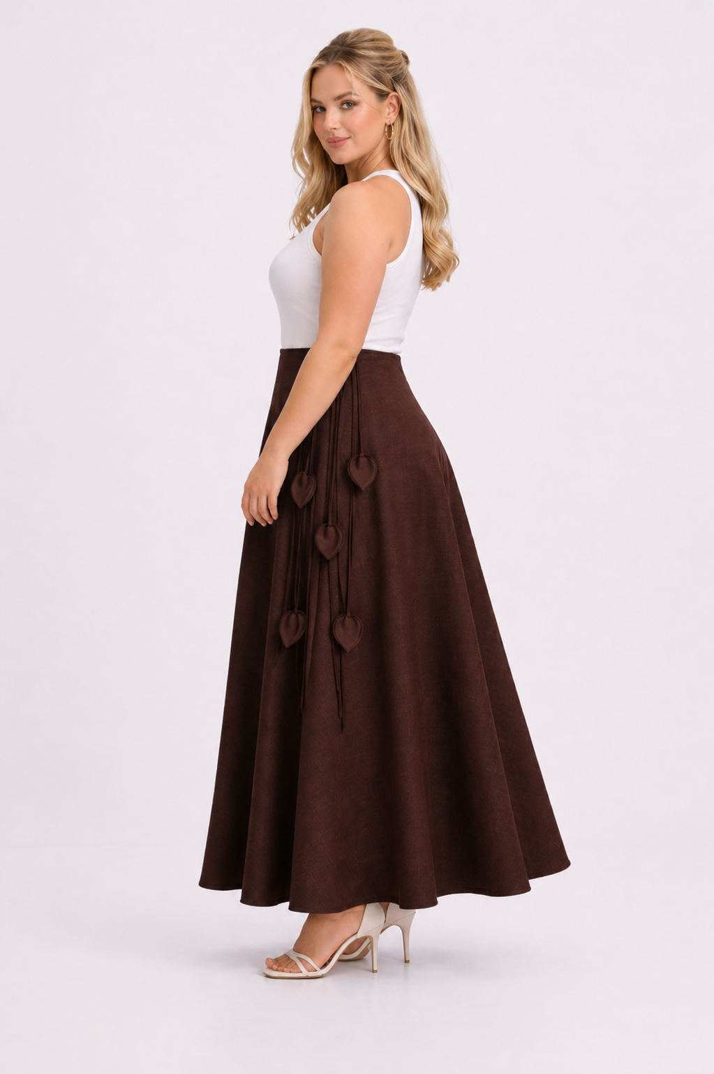 Woman wearing a white top and brown skirt on a white background