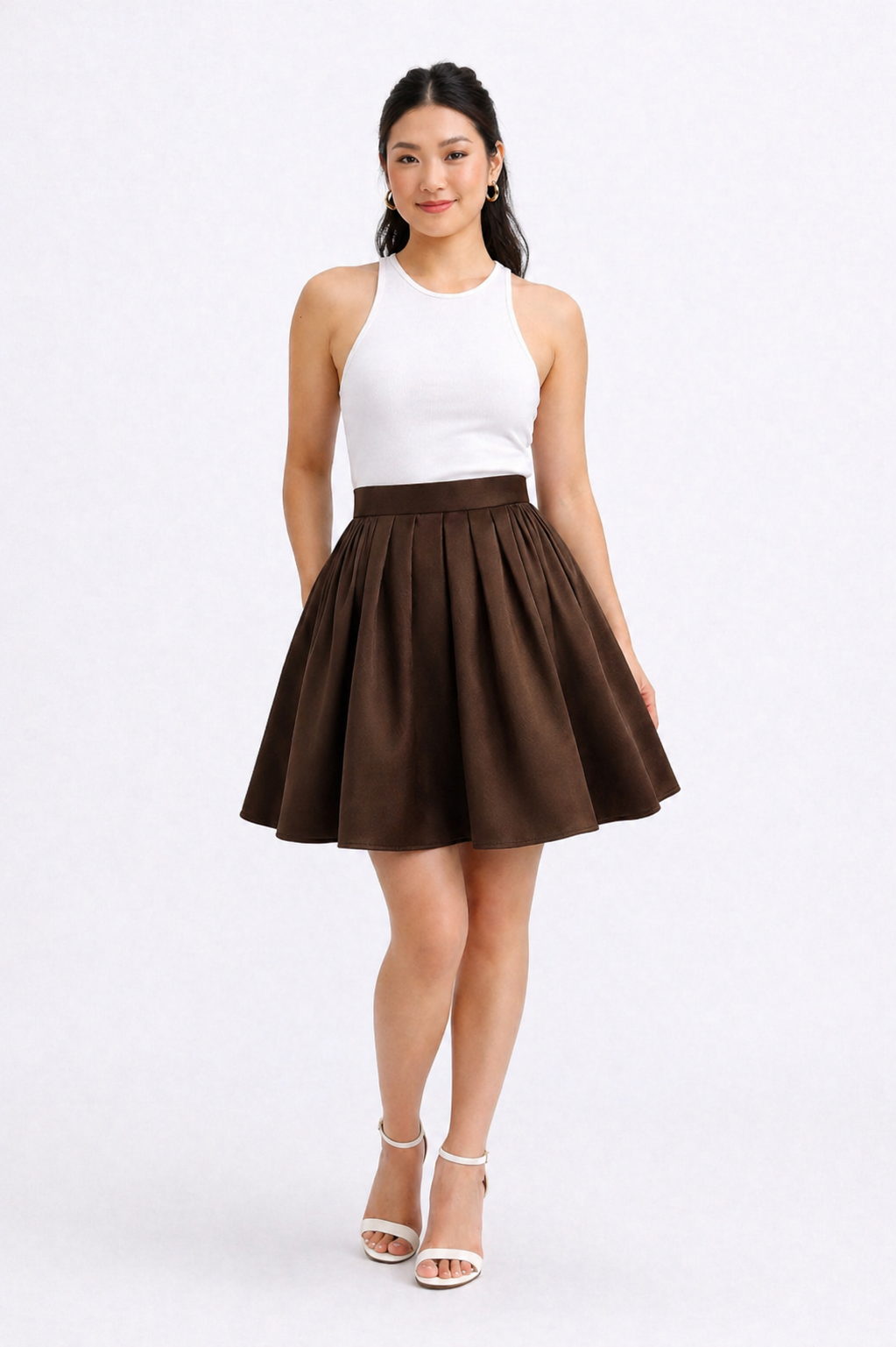 Woman wearing a white top and brown skirt on a white background