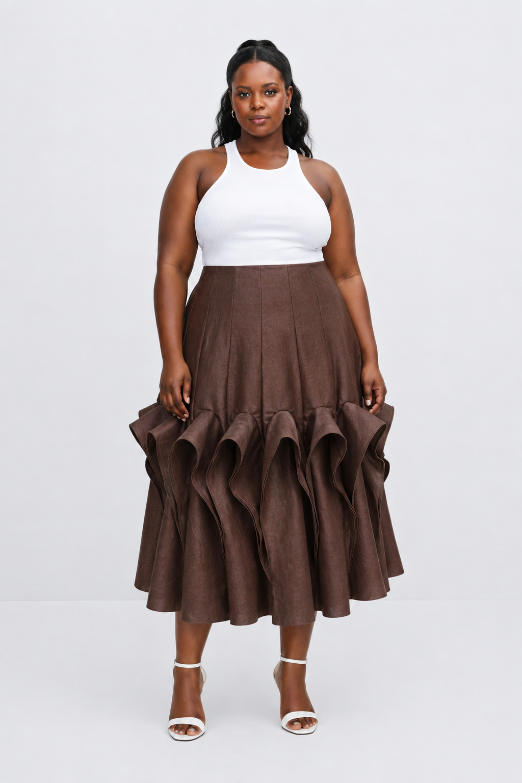 Woman wearing a white top and brown ruffled skirt on a white background