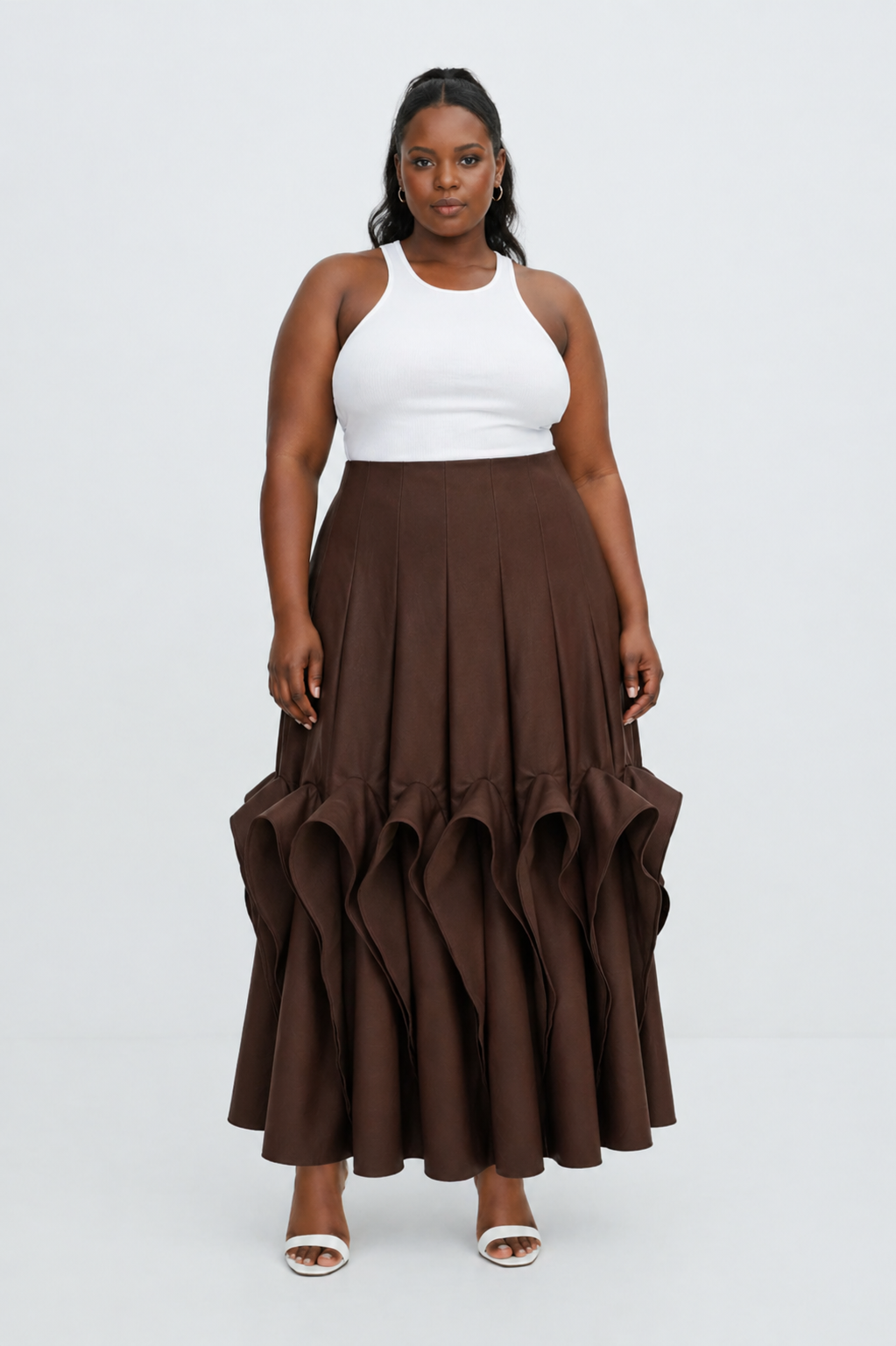 Woman wearing a white top and brown ruffled skirt on a white background