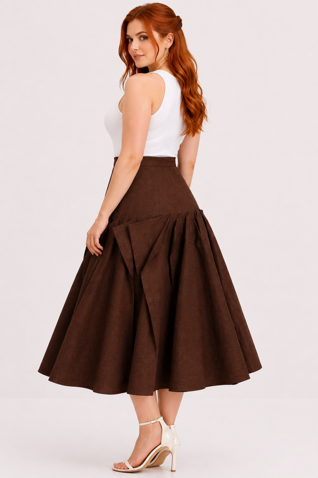 Woman wearing a white top and brown skirt on a white background