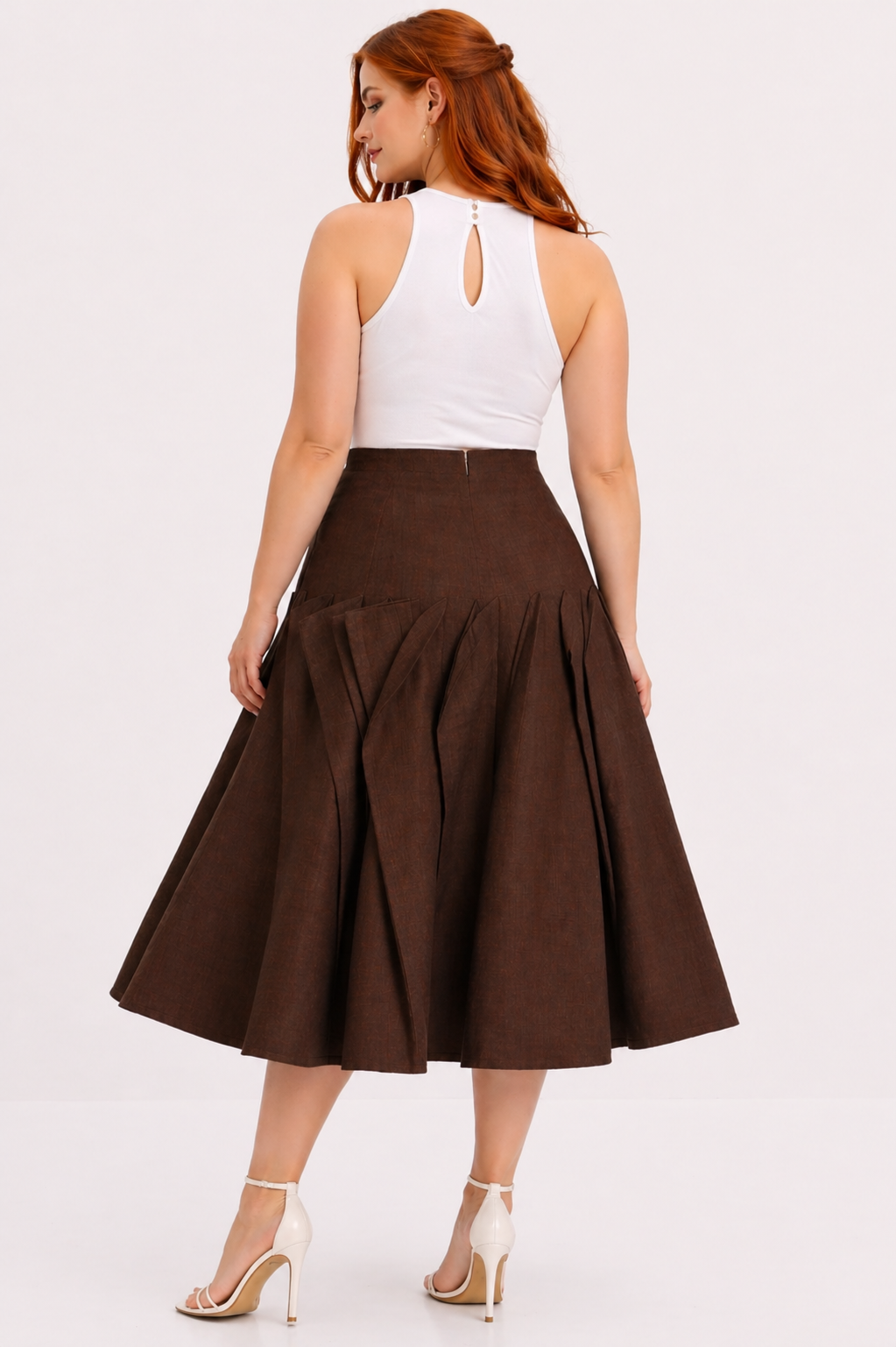 Woman wearing a white top and brown skirt on a white background