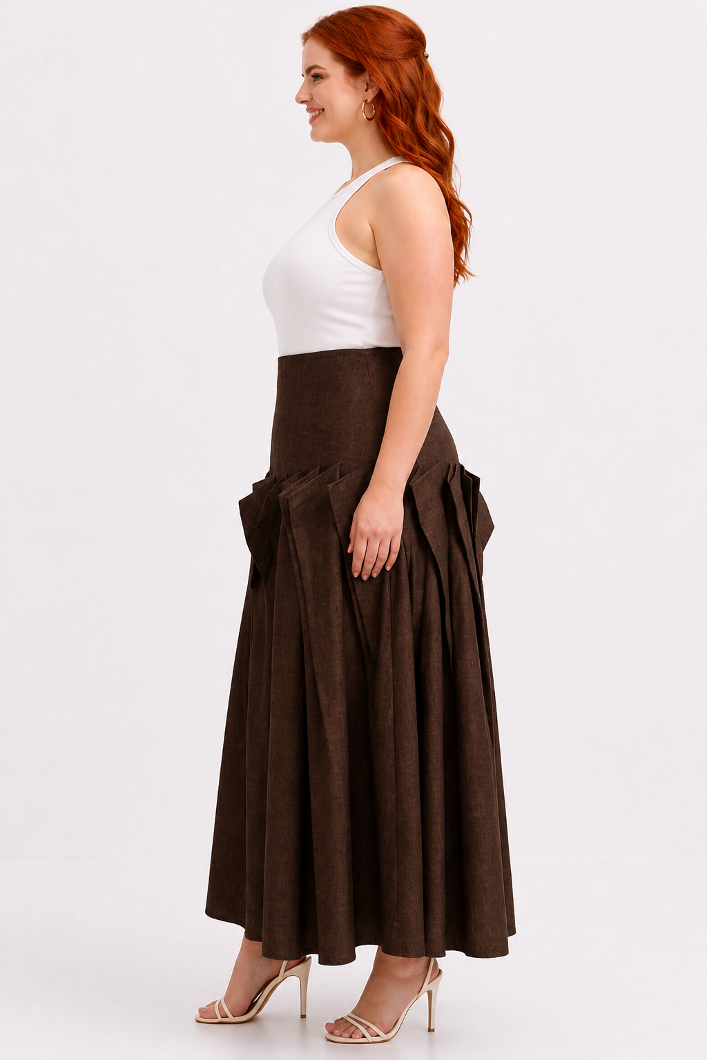 Woman wearing a white top and brown skirt on a white background