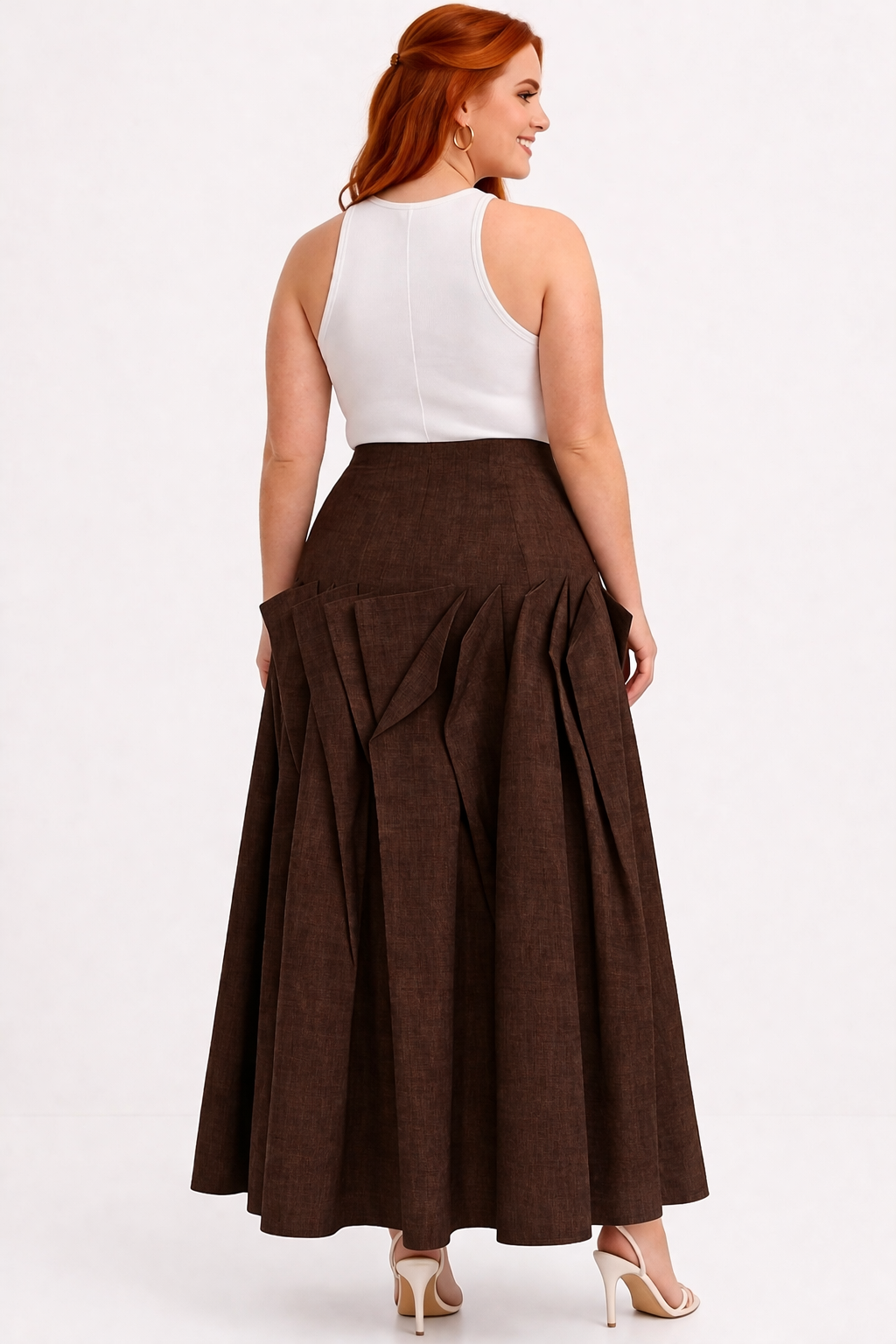 Woman wearing a white top and brown maxi skirt on a white background