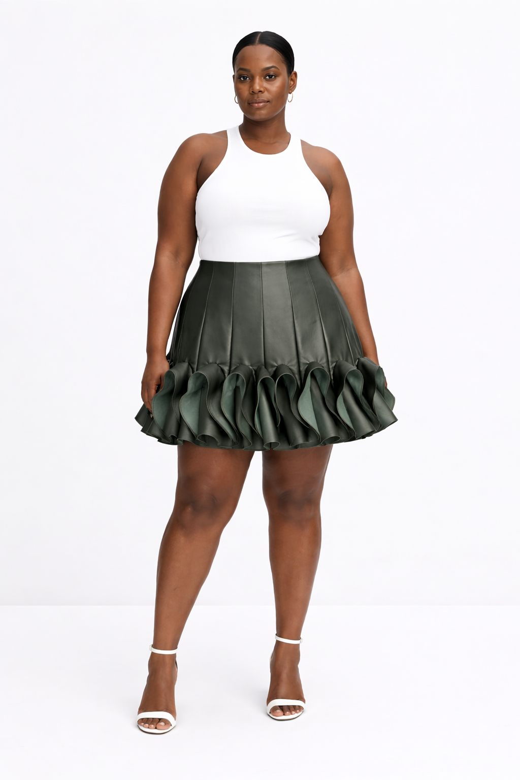 Woman wearing a white top and green kingdom of daughters pleated skirt on a white background