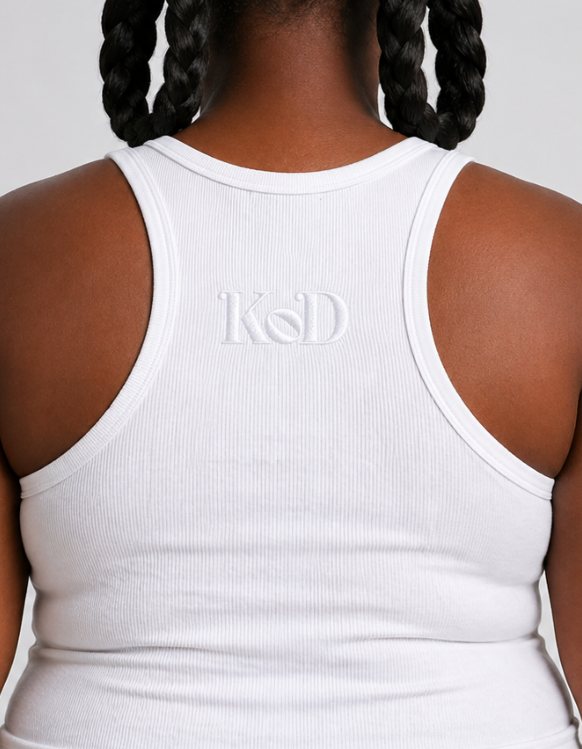 White Kingdom of Daughters tank top with 'KOD' logo on a plain background
