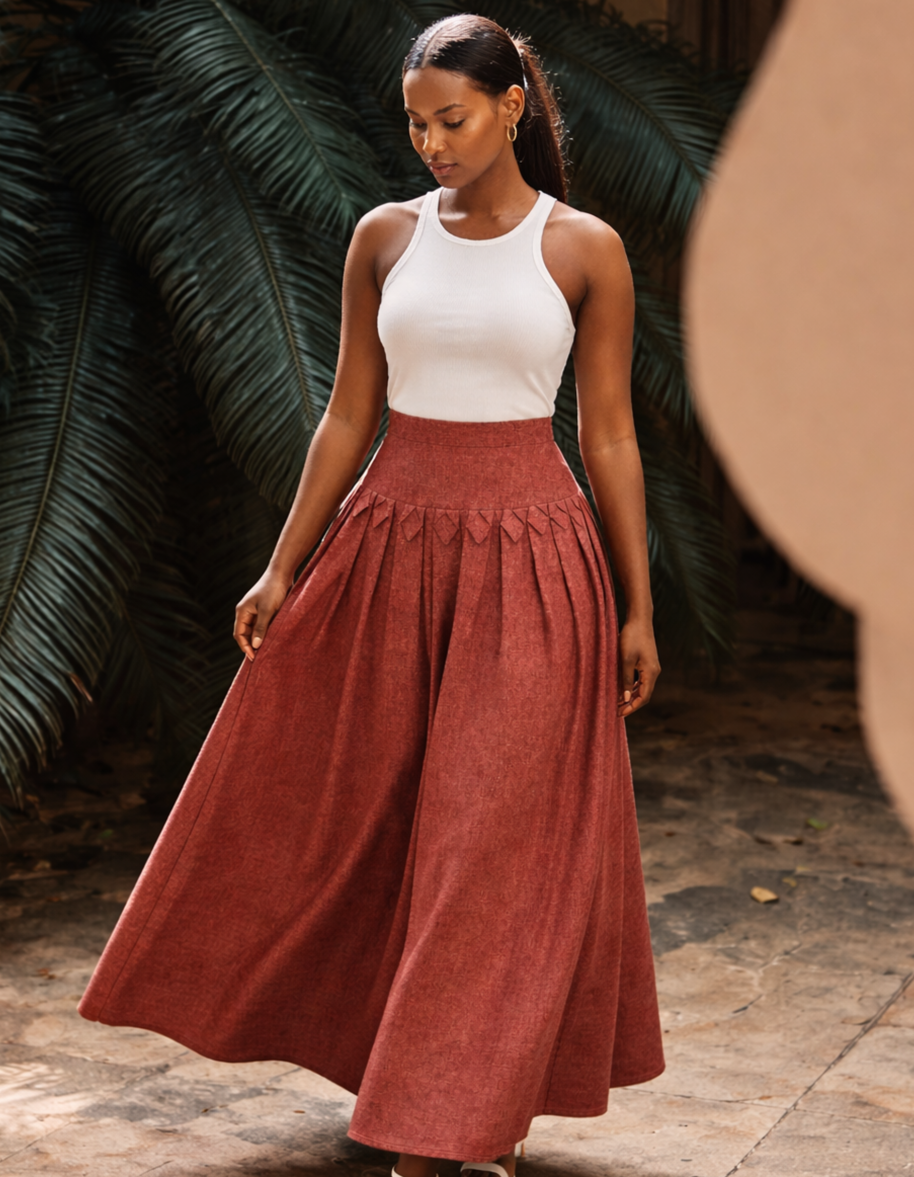 LAdy wearing Kingdom of daughters skirt in a courtyard