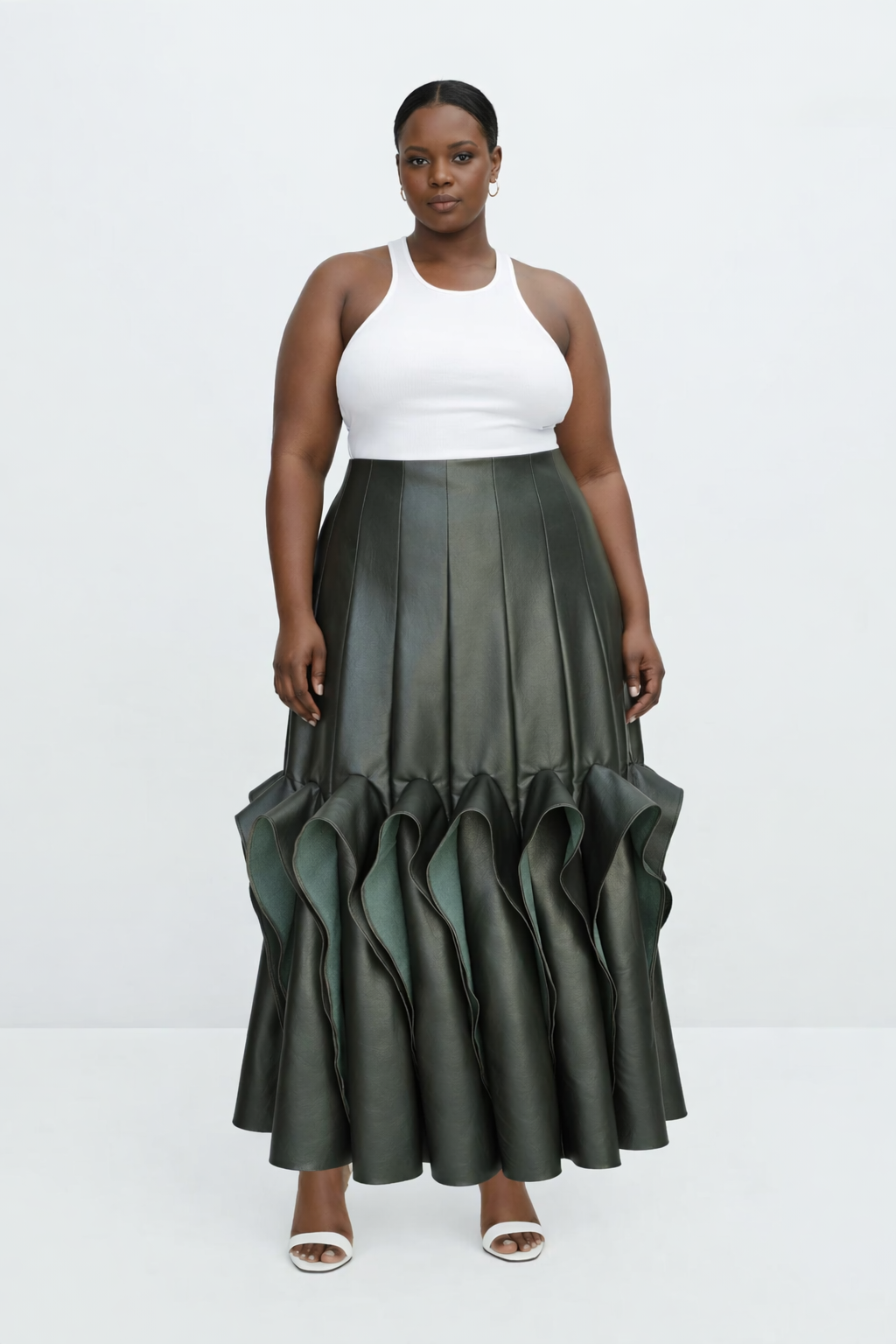 Woman wearing a white top and green ruffled kingdom of daughters skirt on a white background