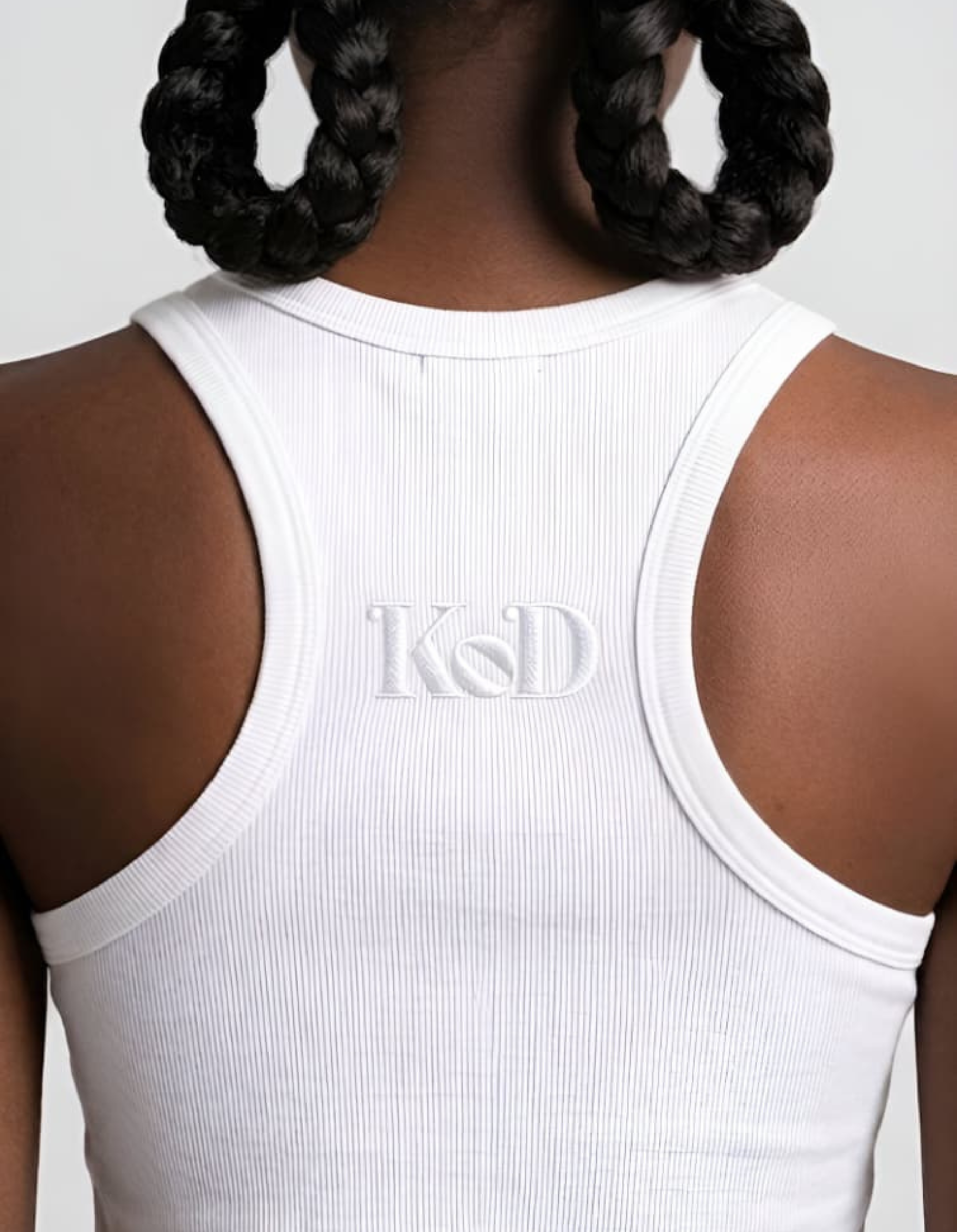 White Kingdom of Daughters tank top with 'KOD' logo on a plain background