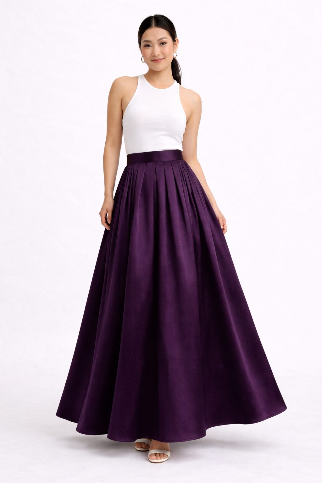 Woman wearing a white top and purple skirt on a white background